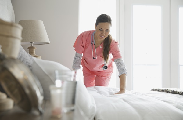 Verpleegster maakt bed op